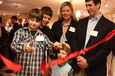 Diana and Jason Frucci with their children cutting the ribbon by Christa J Newman